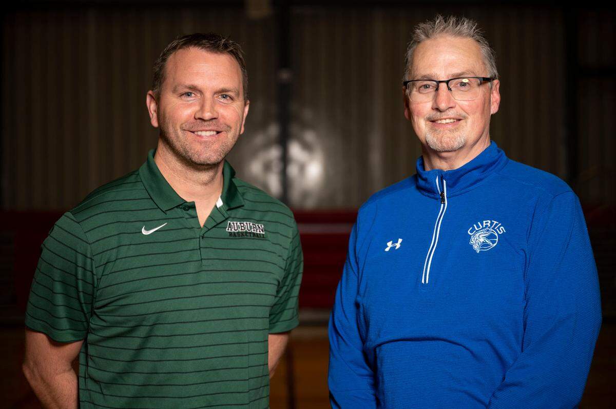 News Tribune coaches of the year Ryan Hansen of Auburn (left) and Tim Kelly of Curtis pose for a portrait on Wednesday, March 16, 2022, at Silas High School in Tacoma, Wash.