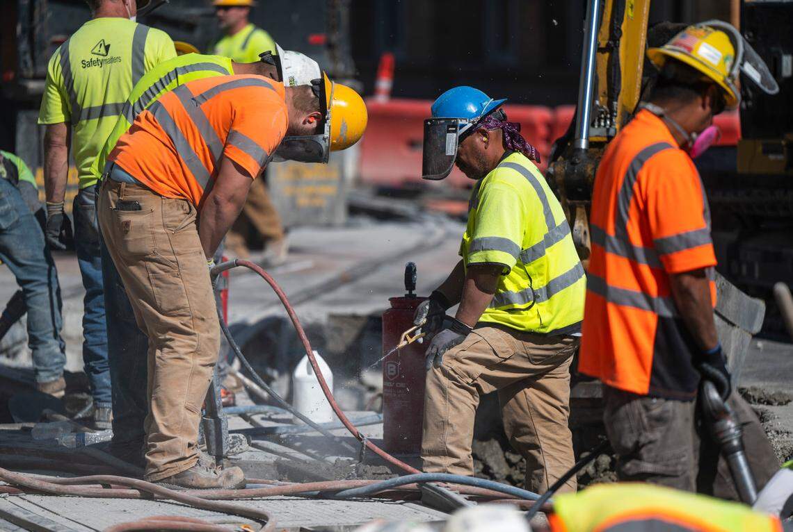 Construction crews work on a project to connect the Hilltop Link Extension to Tacoma Link on South 7th and Commerce streets in downtown Tacoma, Wash. on Sept. 20, 2022.
