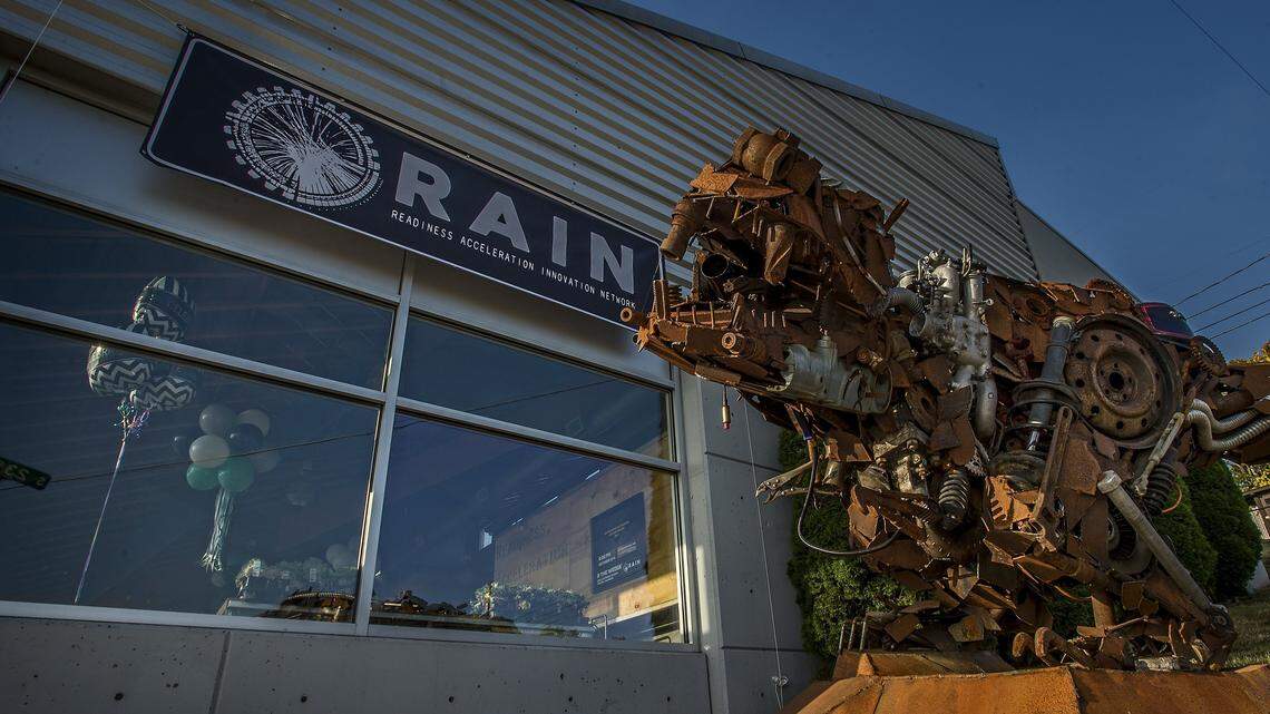A metal sculpture of a dinosaur sits outside the headquarters of the Readiness Acceleration & Innovation Network, or RAIN. The startup is a biotech incubator that is the latest business and science startup for Tacoma. They want to be a life science research hub