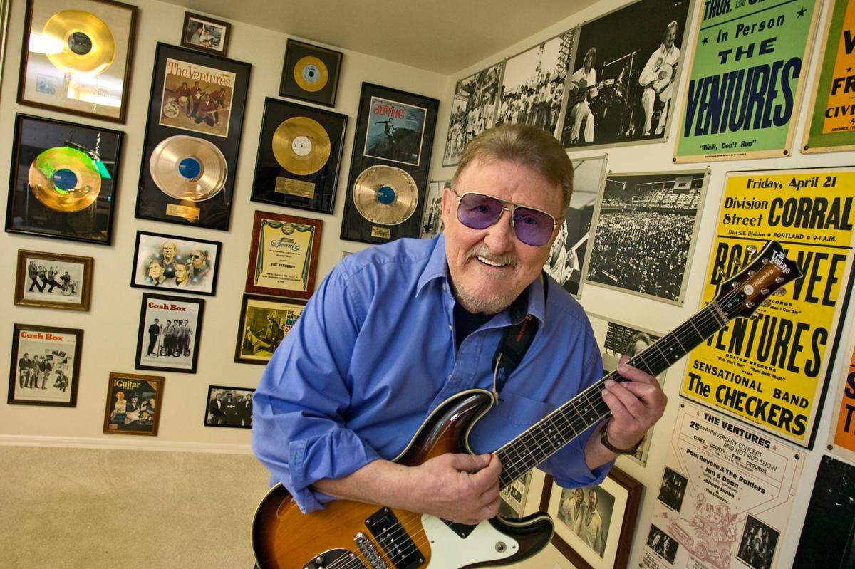 Don Wilson poses with his gold records, photos and other memorabilia after many years in the music biz as guitarist with The Ventures. This is in his Lake Sammamish-area home. Wilson died in early 2022.