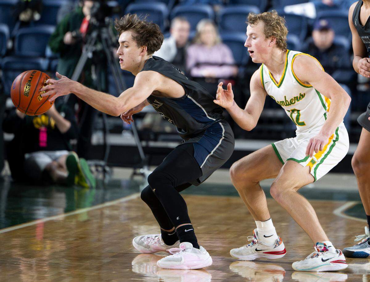 Glacier Peak’s Josiah Lee (2) loses the ball out of bound against Richland’s Joshua Woodard (12) during the semifinals game of the Class 4A state tournament at the Tacoma Dome, on Friday, March 1, 2024, in Tacoma, Wash.