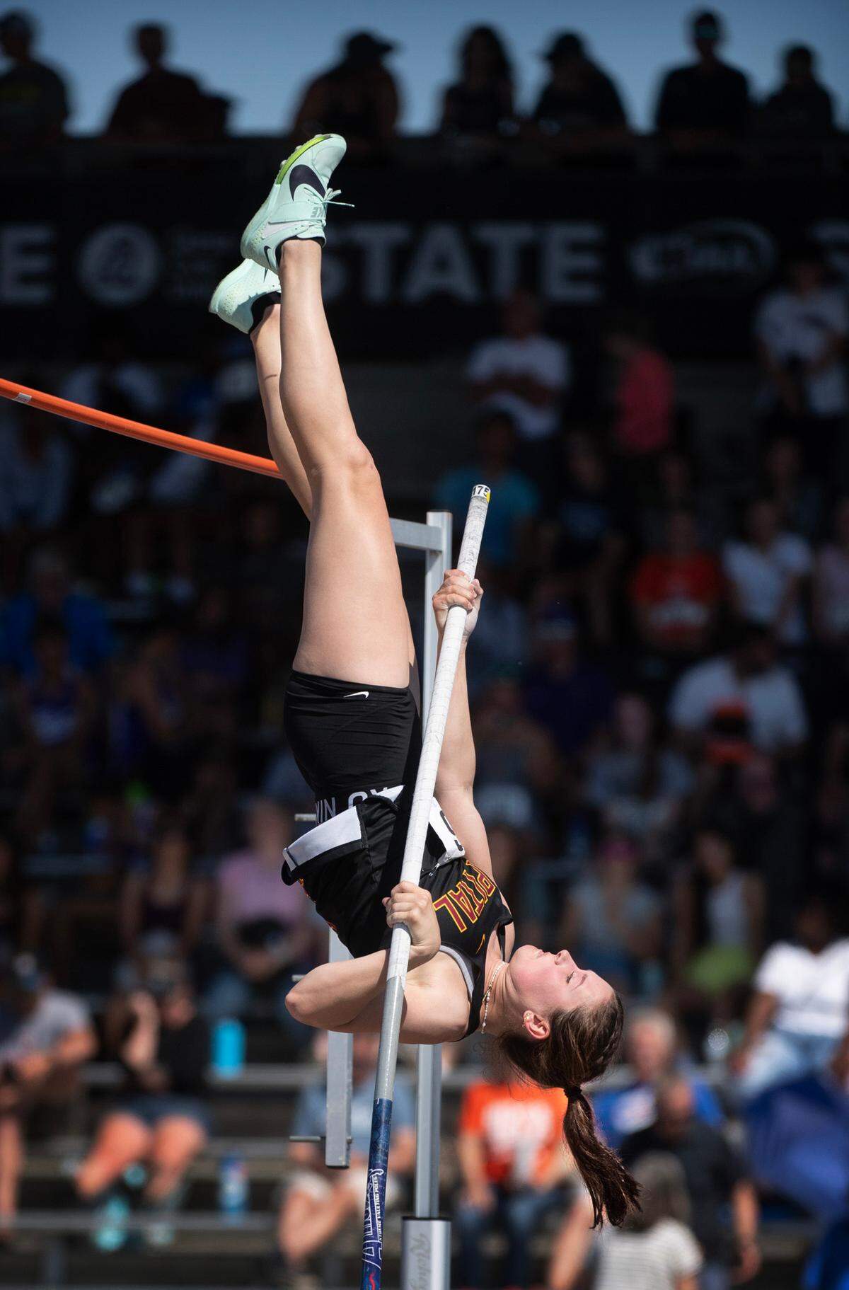 Capital’s Hana Moll goes up and over the bar en route to a a state title and new meet record of 14’ 7” during the second day of the WIAA state track and field championships at Mount Tahoma High School in Tacoma, Washington, on Friday, May 26, 2023.