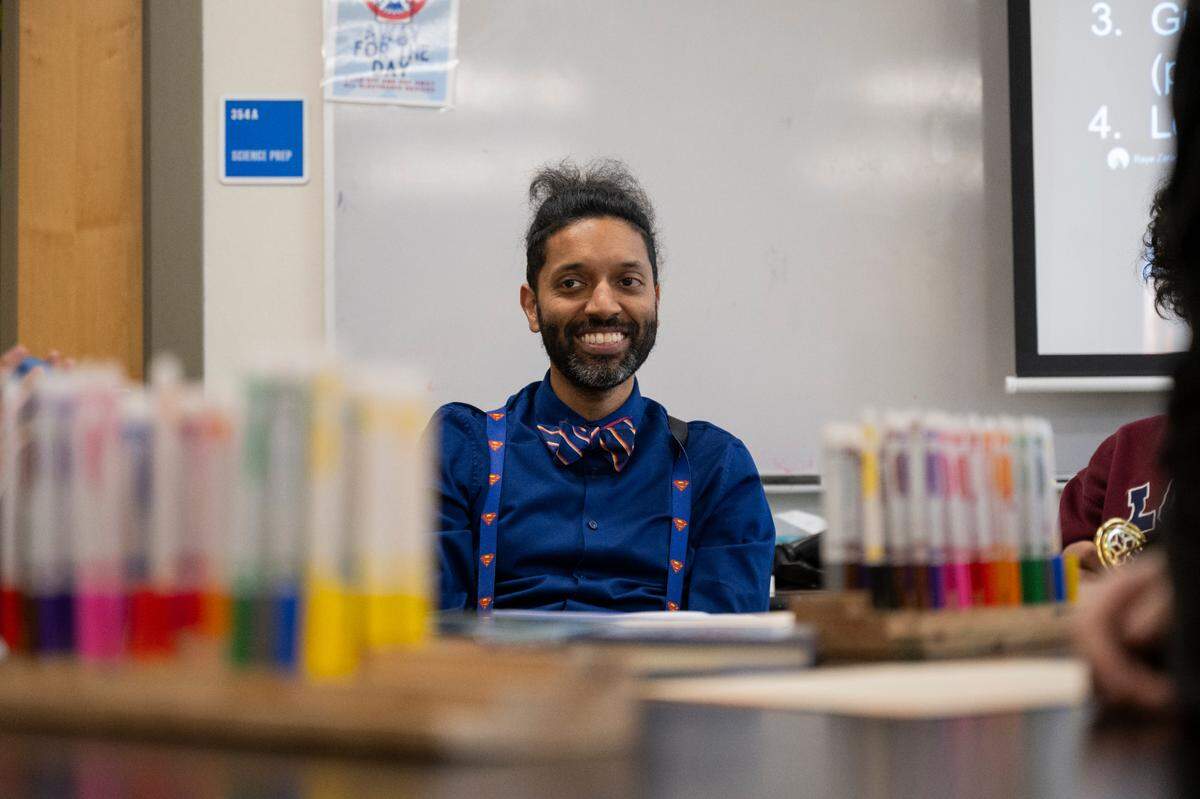 Elliot Scaife, science teacher and adviser for the BIPOC Club, reads and works with students during the BIPOC Club meeting at Orting Middle School, on Wednesday, March 6, 2024, in Orting, Wash.