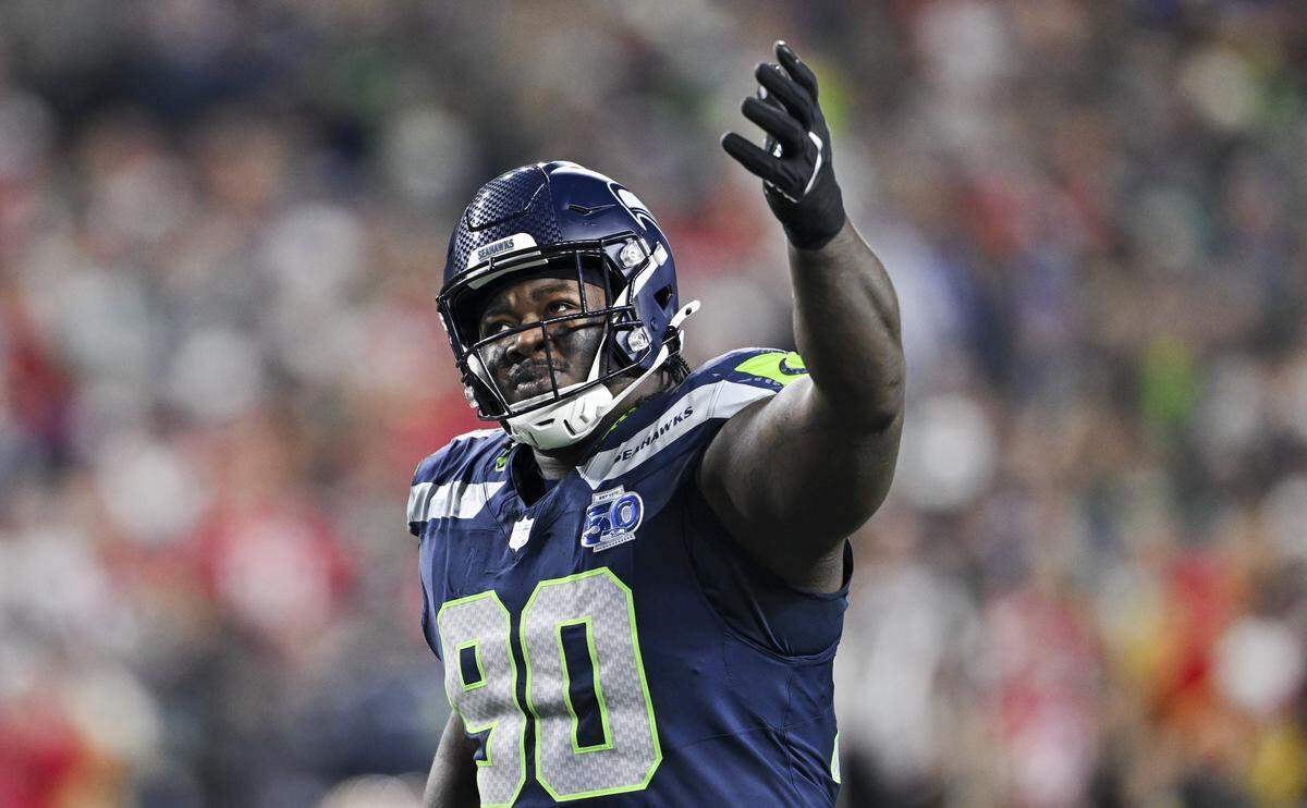 Seattle Seahawks defensive tackle Jarran Reed (90) alls for fans to yell as the San Francisco 49ers are backed up into their own end zone during the second quarter of the NFC Divisional Round game at Lumen Field, on Saturday, Jan. 17, 2026, in Seattle.