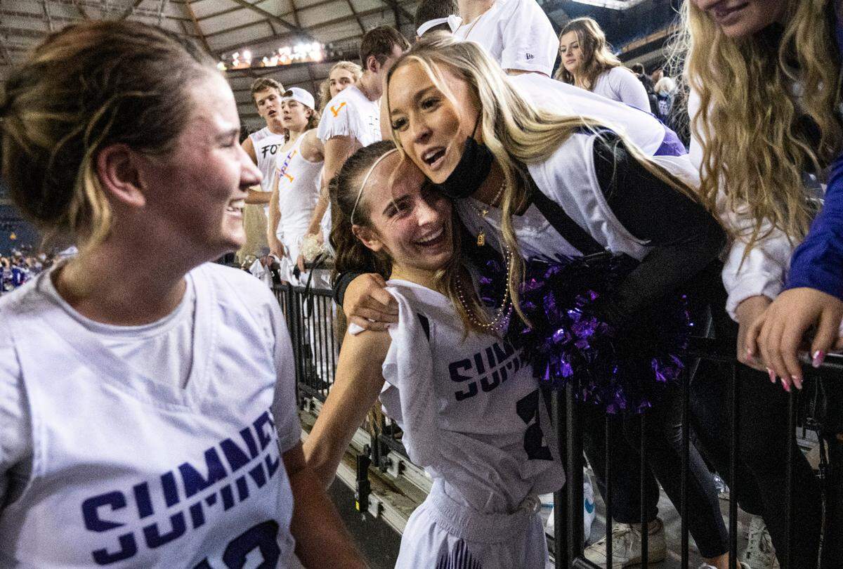 Sumner’s guard Kaylee Cooper (2) hugs Sumner senior Sophia Padero in the stands after winning the Class 4A quarterfinal state tournament game on Thursday, March 3, 2022, at the Tacoma Dome, in Tacoma, Wash.