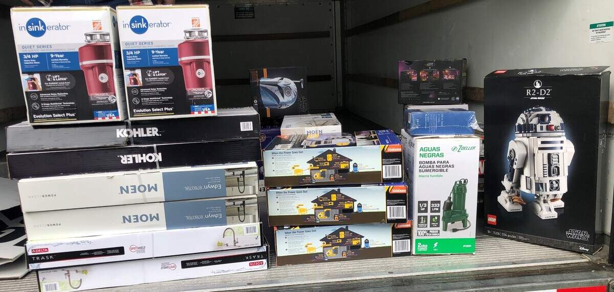 Stolen merchandise is stacked inside a Federal Way residence on June 20, 2023. Renton police tracked stolen Lego sets and kitchen appliances to the suspect’s home.