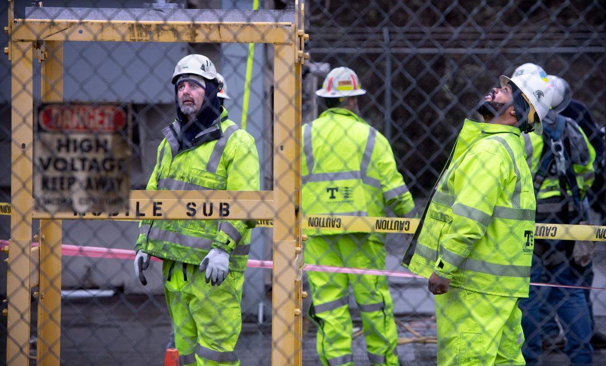 Tacoma Public Utilities workers switch the 224th Street East substation to a mobile transformer to restore power in Graham, Washington, on Monday, Dec. 26, 2022.