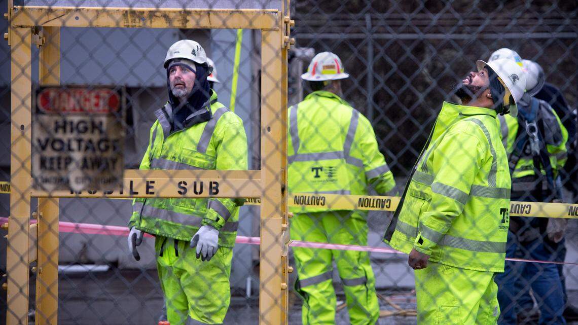 Tacoma Public Utilities workers switch the 224th Street East substation to a mobile transformer to restore power in Graham, Washington, on Monday, Dec. 26, 2022.