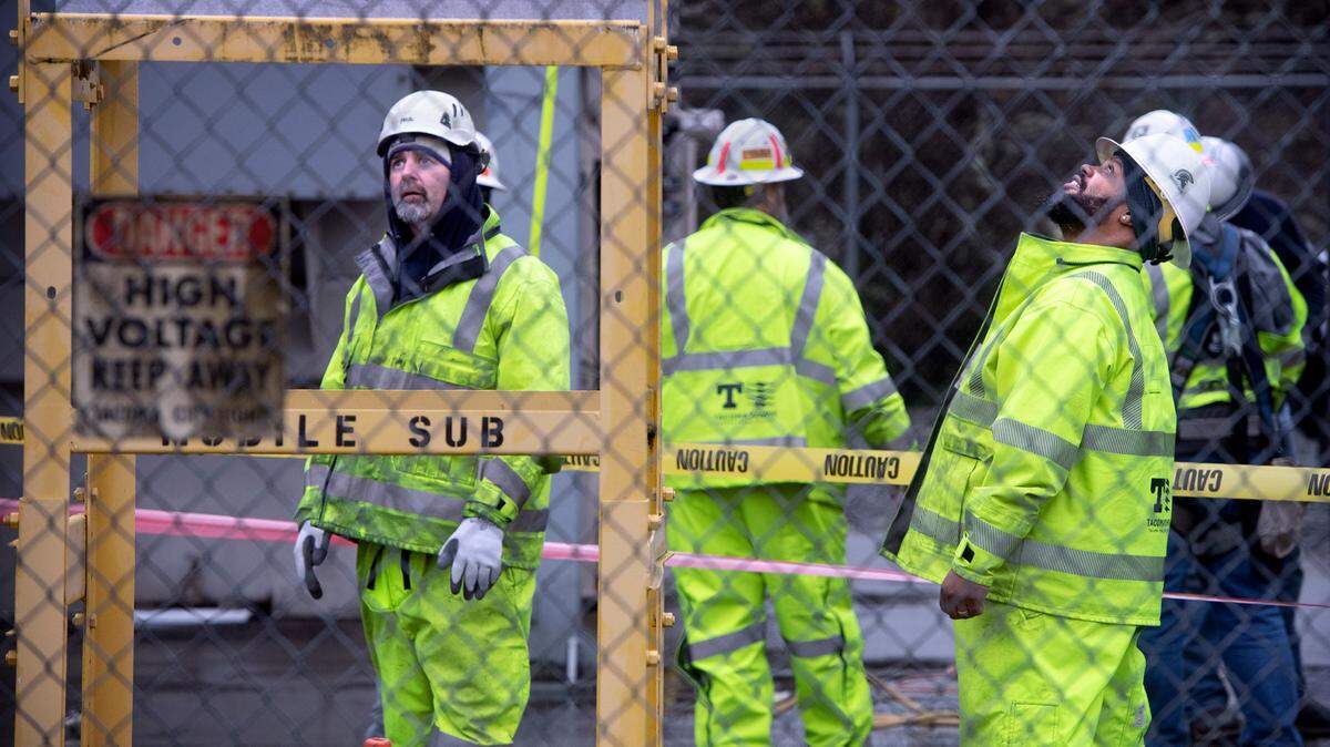 Tacoma Public Utilities workers switch the 224th Street East substation to a mobile transformer to restore power in Graham, Washington, on Monday, Dec. 26, 2022.