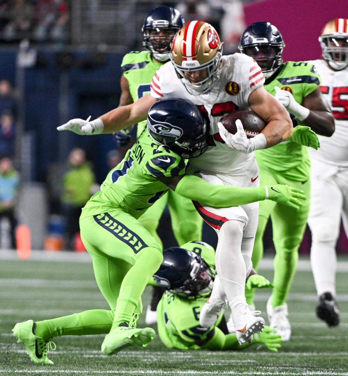 San Francisco 49ers running back Christian McCaffrey (23) is tackled by Seattle Seahawks cornerback Devon Witherspoon (21) during the first quarter of the game at Lumen Field, Thursday, Nov. 23, 2023, in Seattle, Wash.