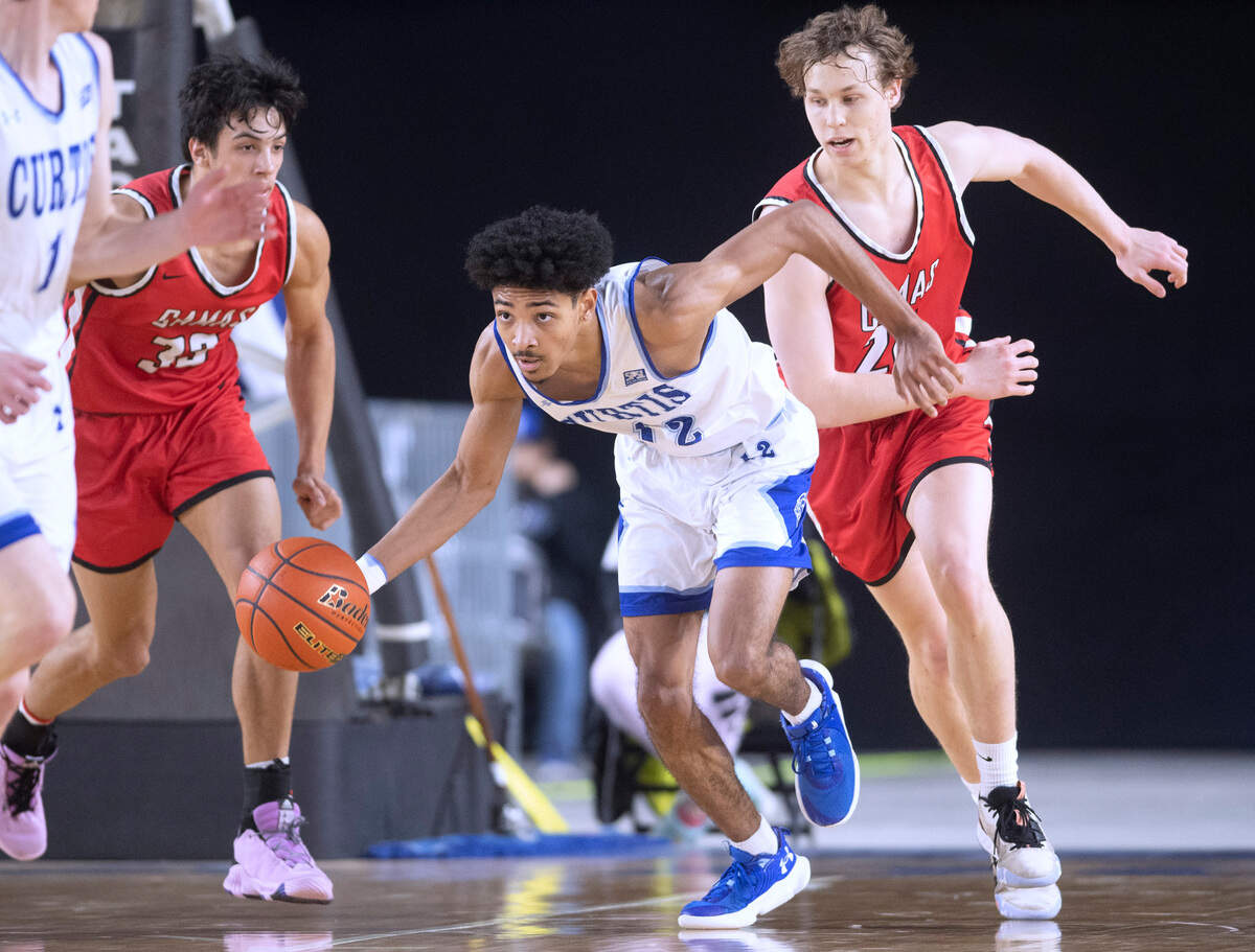 Curtis’ Cinque Maxwell pushes the ball up court in front of Camas defenders Jamison Carlisle (left) and Josh Dabasinskas during their state quarterfinal game at the WIAA state basketball tournament in the Tacoma Dome in Tacoma, Washington, on Wednesday, March 1, 2023. Curtis won the game, 73-46