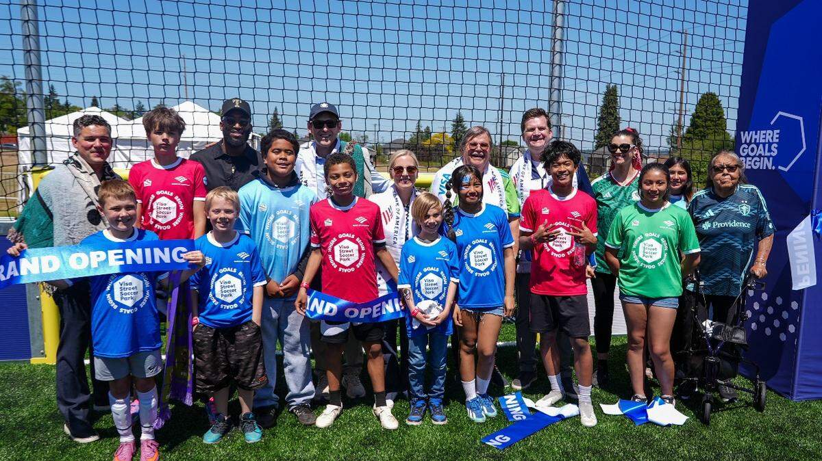 Bill Sterud and Connie McCloud of the Puyallup Tribe of Indians celebrate the opening of the Visa Street Soccer Park along with community partners and local youth.