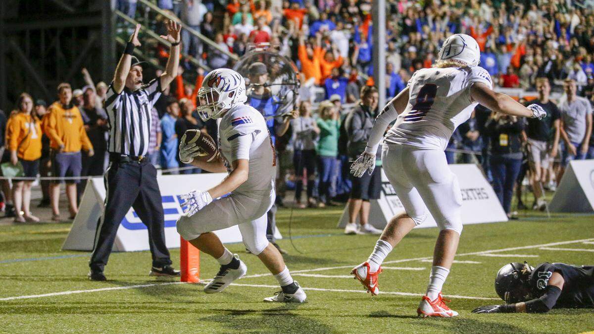 Graham-Kapowsin’s Jonas Waugh scores the game-winning two-point conversion to give the Eagles a 51-50 overtime win over Sheldon at Sheldon High School.