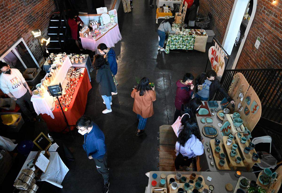 People shop at the Rain or Shine Community Market in The Drake on Pacific Avenue on Sunday, April 3, 2022 in Tacoma, Wash. The market is a BIPOC-focused market with venders selling jewelry, candles, handmade pottery, food and more.