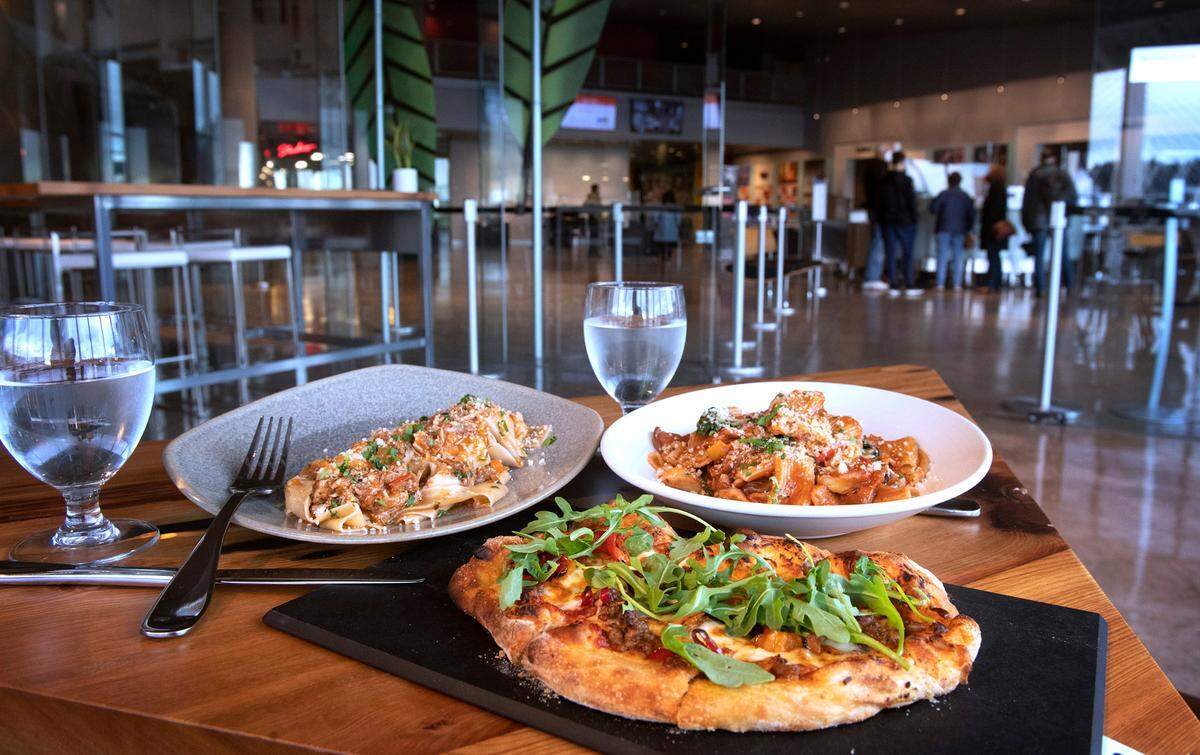 Pappardelle pork ragu (left), a fennel sausage pizza with pickled peppers, and the roasted mushroom ragu with spicy rigatoni at the new Incalmo restaurant adjacent to the Museum of Glass in downtown Tacoma, Washington, on Wednesday, Dec. 22, 2021.
