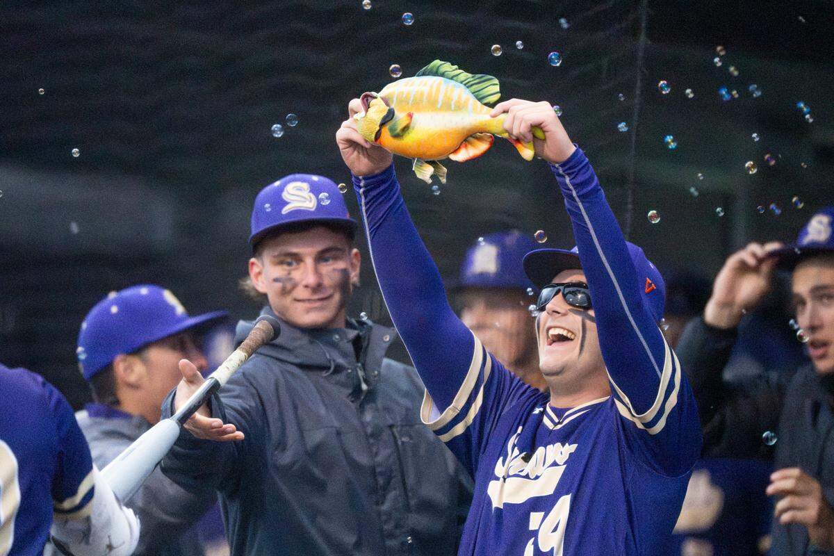 Sumner celebrates a run against Puyallup by hoisting a fish and blowing bubbles during a 4A district championship game on Saturday, May 17, 2025, at Tahoma High School in Maple Valley, Wash.