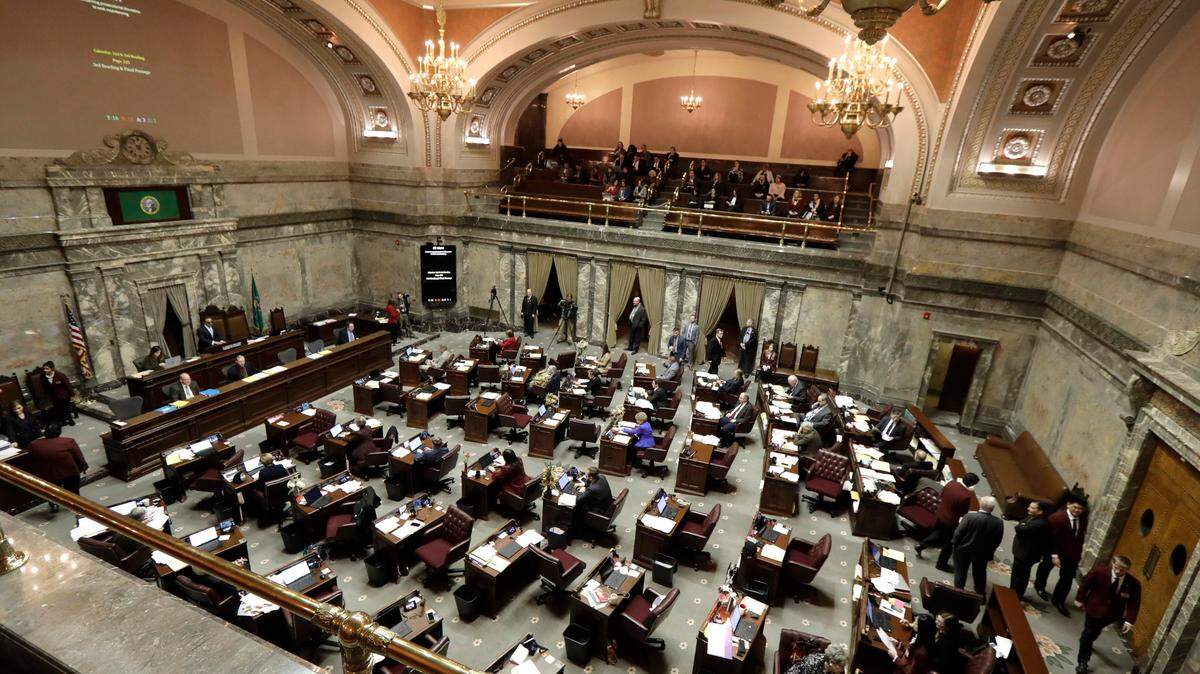 Lawmakers work on the Senate floor, Wednesday, Feb. 19, 2020, at the Capitol in Olympia, Wash. Lawmakers were busy throughout the day, as Wednesday was the floor cutoff deadline for the 2020 legislative session. (AP Photo/Ted S. Warren)