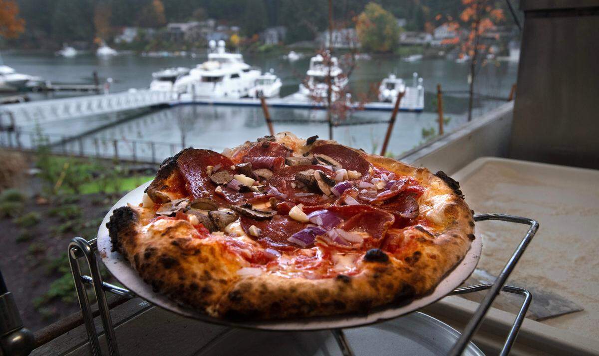 A pizza fresh out of the oven at the Millville at 7 Seas wood-fired pizza truck in the parking lot of 7 Seas Brewing on the waterfront in Gig Harbor, Washington, on Monday, Nov. 6, 2023.