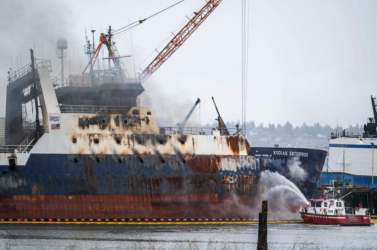Tacoma fire crews work to put out a fire that broke out Saturday on the fishing vessel Kodiak Enterprise, while it was docked in Hylebos Waterway in the Port of Tacoma in Tacoma, Wash. on April 10, 2023.
