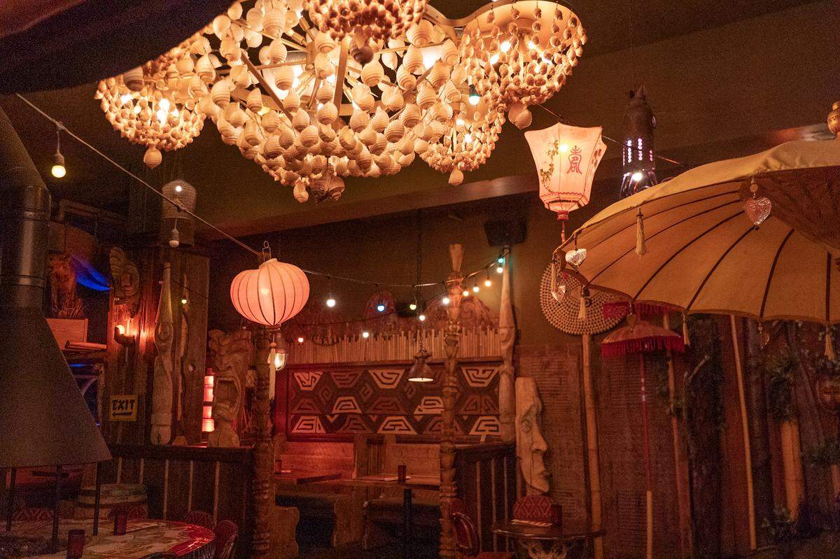 The Old Hangout at McMenamins is decorated like a tiki bar, with shell light fixtures, lanterns, tiki statues and a waterfall.