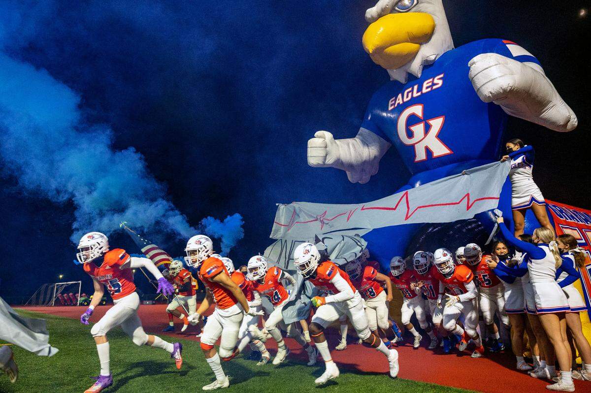 Graham-Kapowsin runs through its Eagle mascot tunnel prior to kickoff of a first-round State 4A game against Kentwood on Friday night at Art Crate Field in Spanaway.