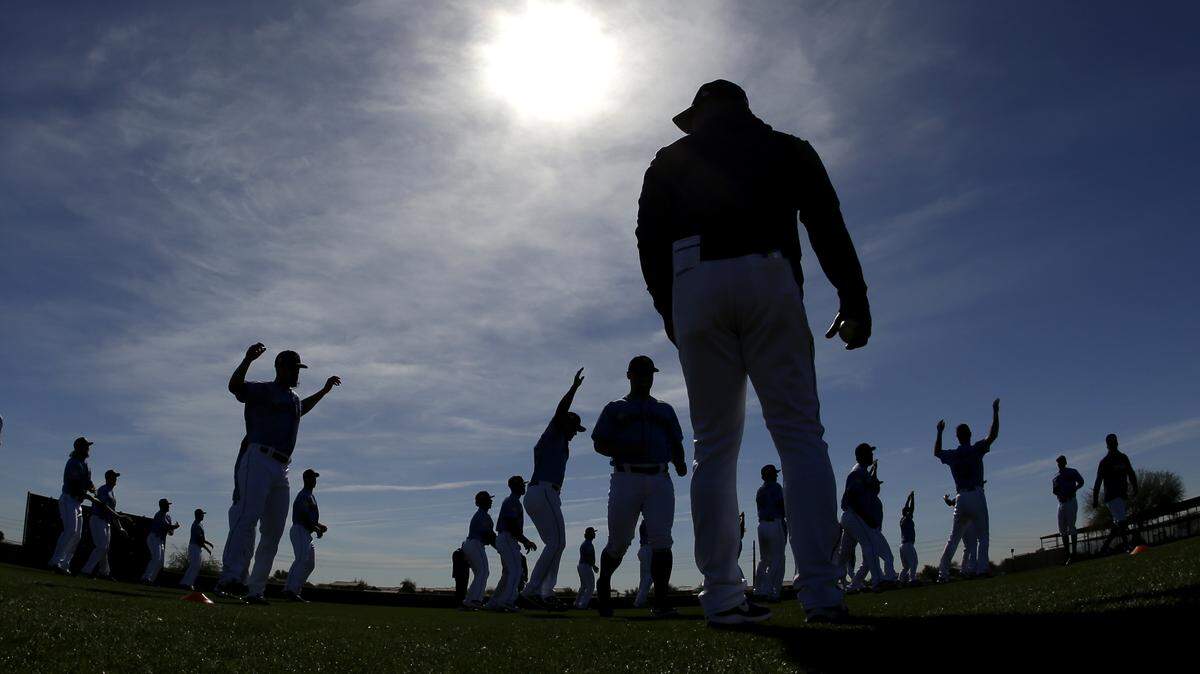 Players for the Seattle Mariners warm up during spring training baseball practice Tuesday, Feb. 12, 2019, in Peoria, Ariz. (AP Photo/Charlie Riedel)