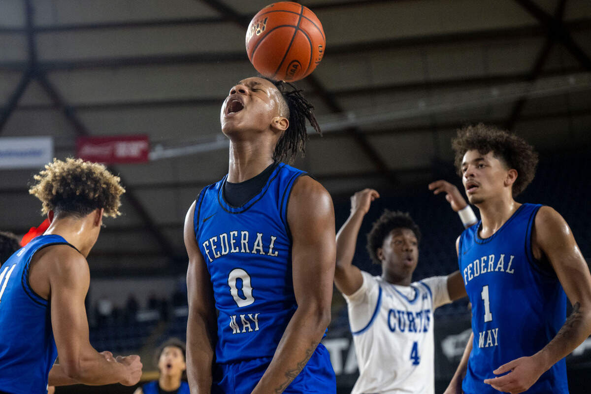 Federal Way forward Vaughn Weems (0) celebrates after making a basket while being fouled during the fourth quarter of a Class 4A semifinal game against Curtis on Friday, March 3, 2023, in Tacoma, Wash.