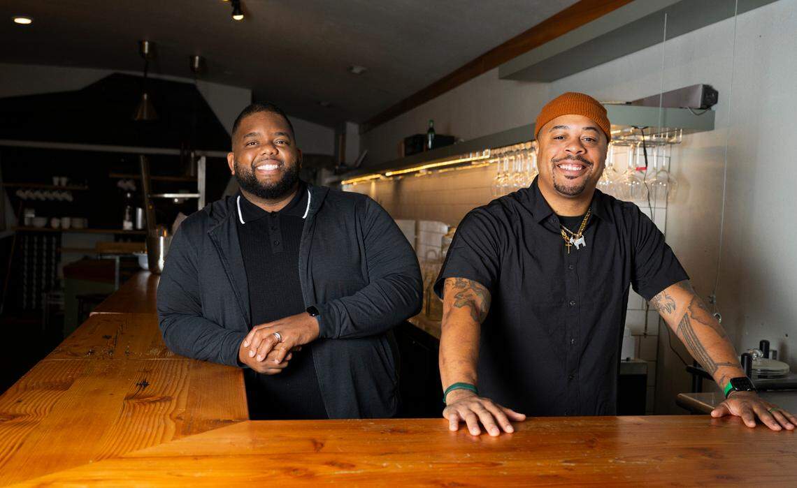 Co-owners Denzel Johnson (left) and Reginald Jacob Howell stand behind the bar on Oct. 15 at their soon-to-be Grann Restaurant, 2717 6th Ave. in Tacoma. The concept will marry Southern barbecue with Indian and Creole flavors.