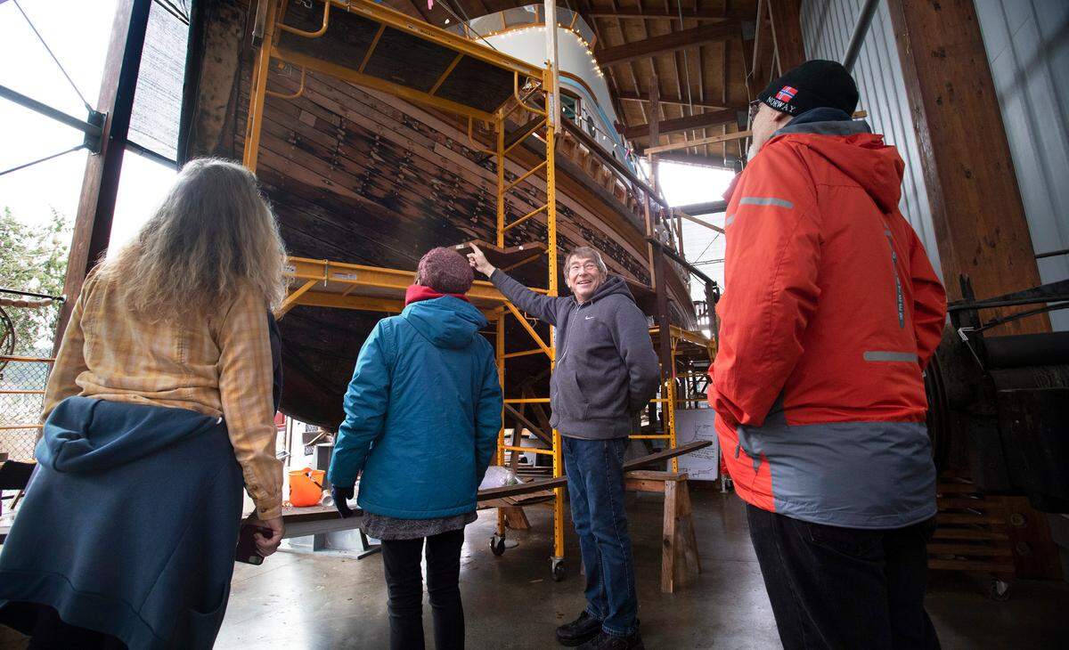 Volunteer Dave Federighi shows off the 65-foot Shenandoah restoration project to visitors at the Harbor History Museum in Gig Harbor, Washington, on Thursday, Feb. 3, 2022.