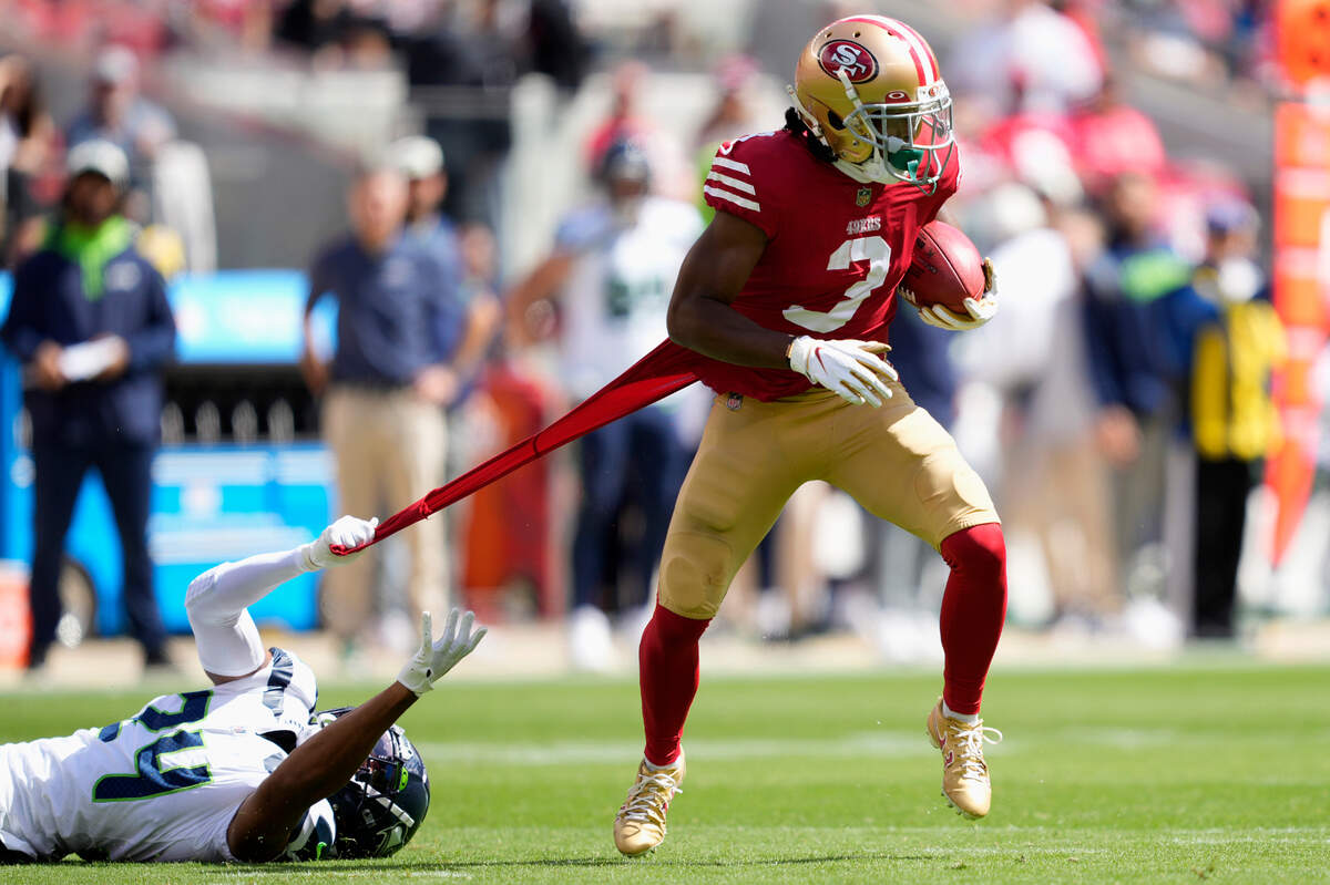 San Francisco 49ers wide receiver Ray-Ray McCloud III (3) runs as Seattle Seahawks cornerback Isaiah Dunn (24) grabs his jersey during the first half of an NFL football game in Santa Clara, Calif., Sunday, Sept. 18, 2022. (AP Photo/Tony Avelar)