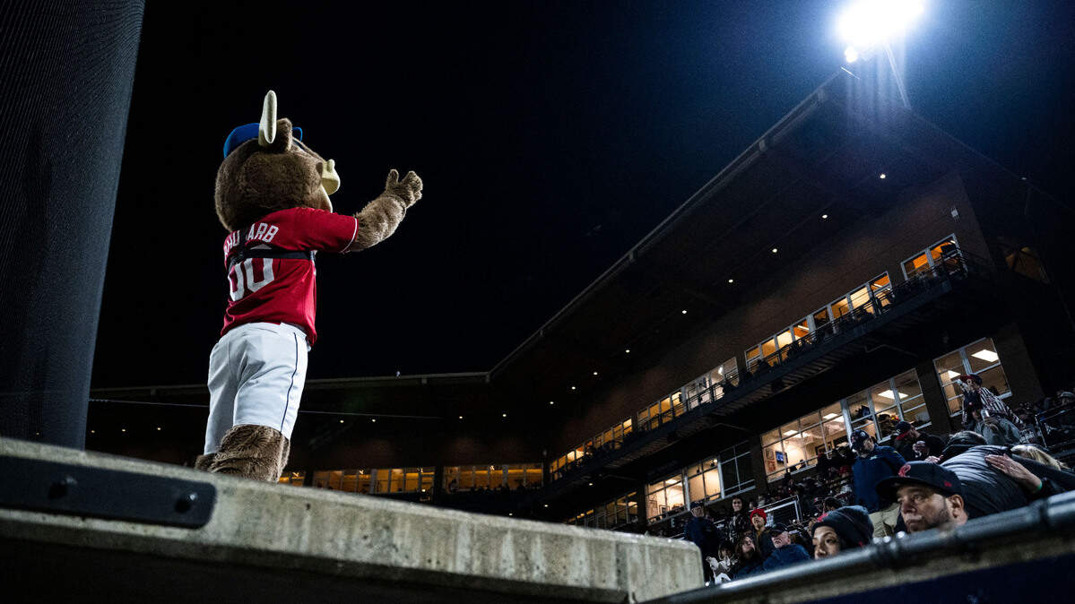 Rhubarb the reindeer waves to fans from the top of the Tacoma Rainiers dugout during the seventh inning of the Rainiers home opener game against the Reno Aces at Cheney Stadium in Tacoma, Wash. on April 4, 2023.