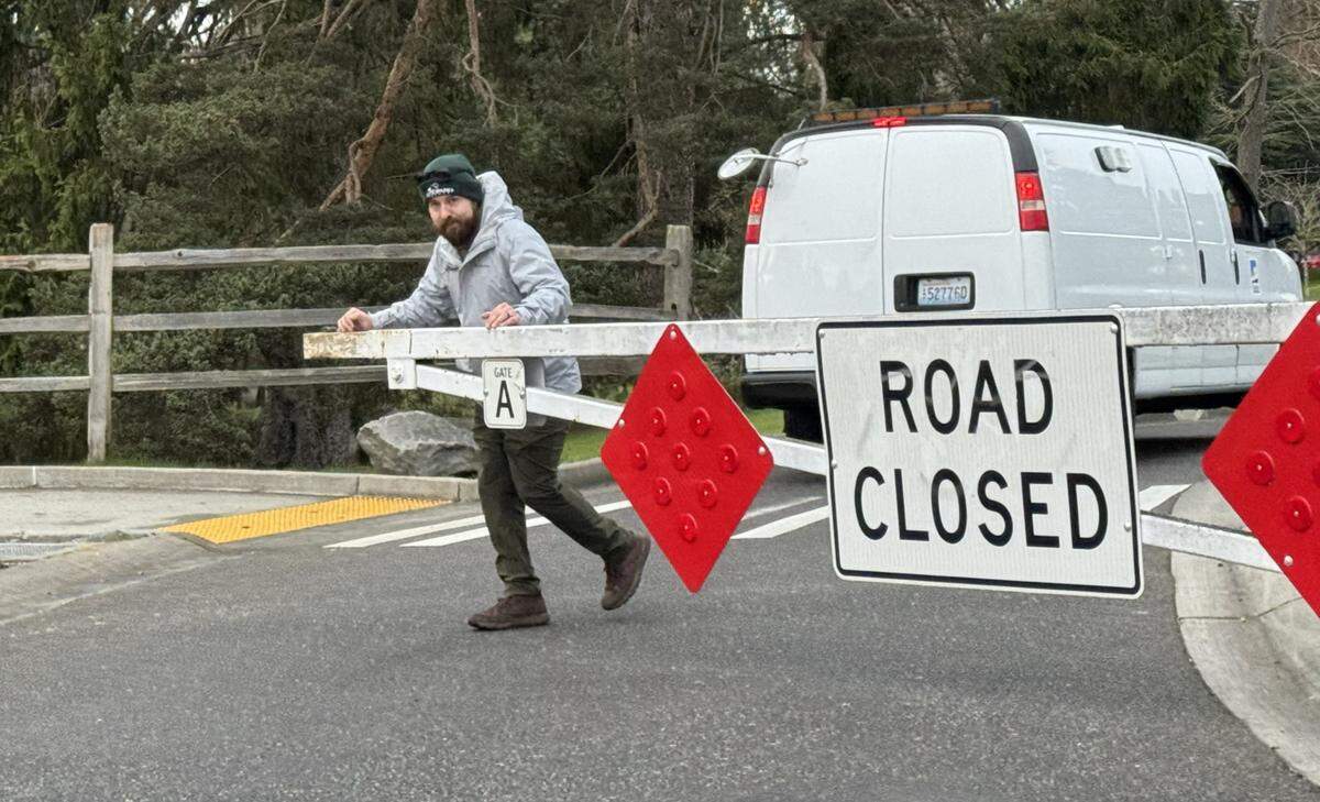 A worker closes the main gate to Point Defiance Park Feb. 10 after allowing a police forensics van to enter to investigate a random stabbing.