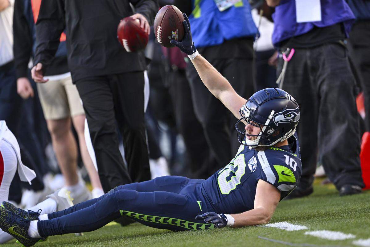 Seattle Seahawks wide receiver Cooper Kupp (10) signals to the referee that he caught a pass from quarterback Sam Darnold as he was falling out of bounds during the first quarter of Super Bowl LX at Levi's Stadium on Feb. 8, 2026 in Santa Clara, Calif.