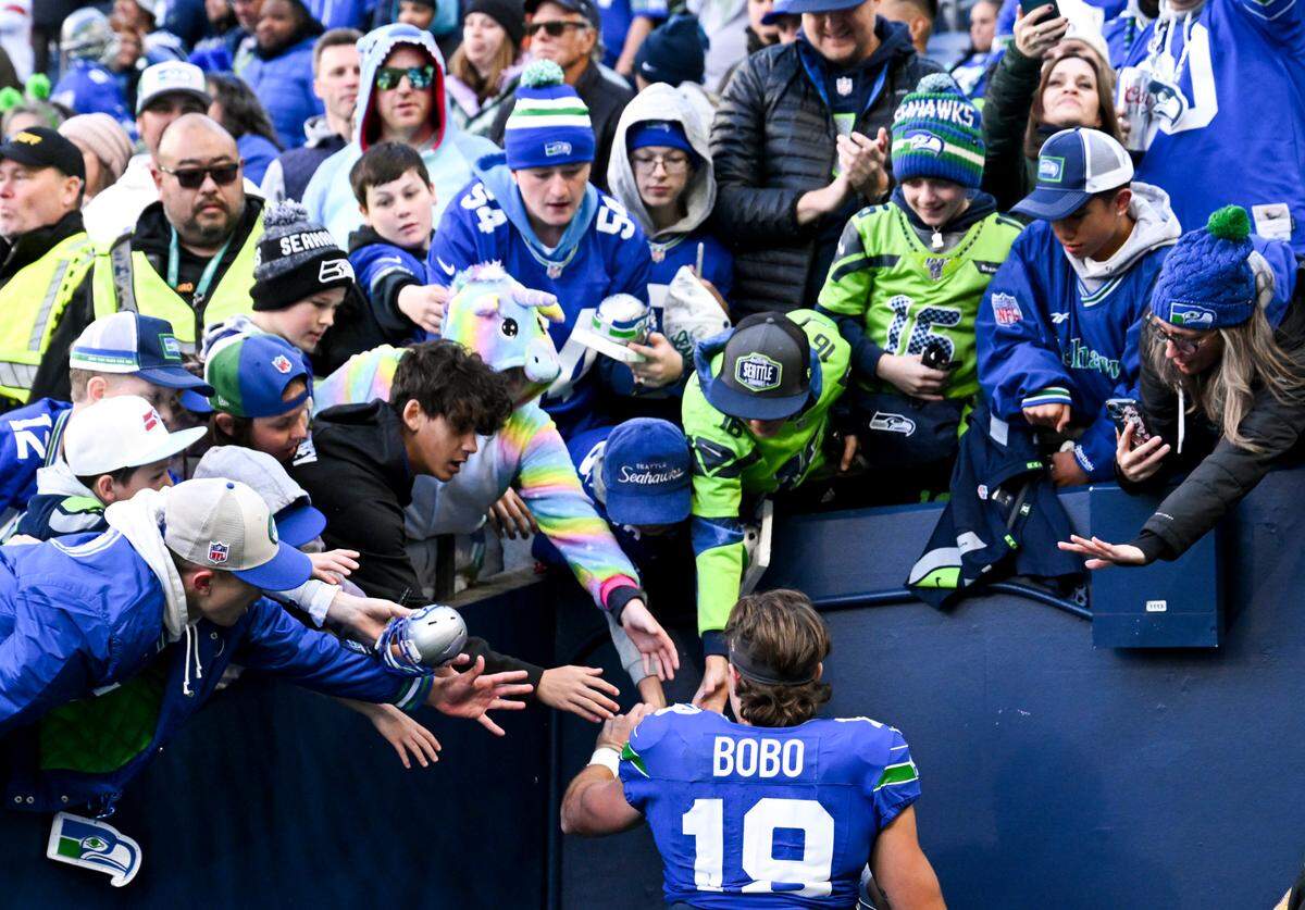 Seattle Seahawks wide receiver Jake Bobo (19) interacts with fans after the Seahawks 24-20 victory at Lumen Field, Sunday, Oct. 29, 2023, in Seattle, Wash.