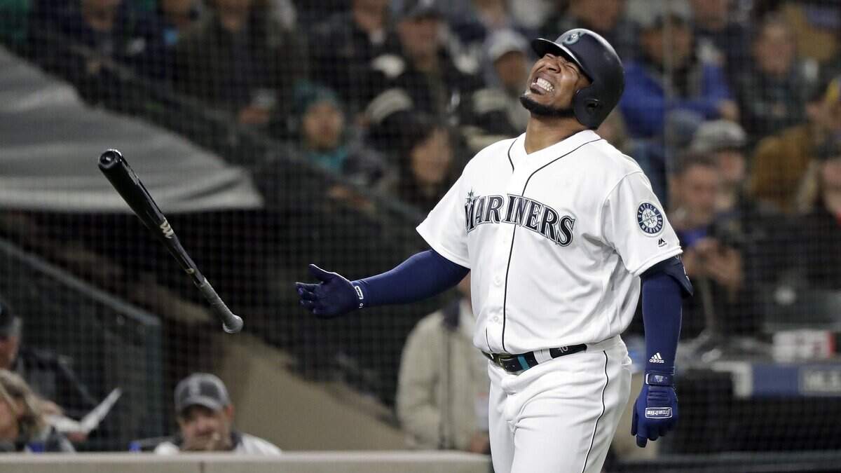 Seattle Mariners’ Edwin Encarnacion reacts to being hit by a pitch against the Texas Rangers in a baseball game Thursday, April 25, 2019, in Seattle. (AP Photo/Elaine Thompson)