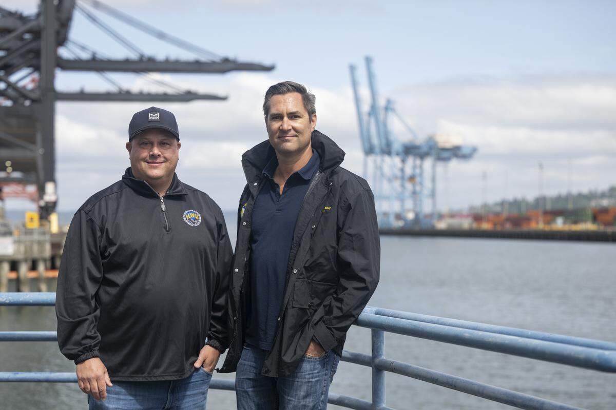 Jared Faker, left, president of the International Longshore & Warehouse Union Local 23, and Brock Graber, vice president of the ILWU Local 23, pose for portrait outside of the Port of Tacoma on Thursday, May 7, 2026, in Tacoma, Wash.