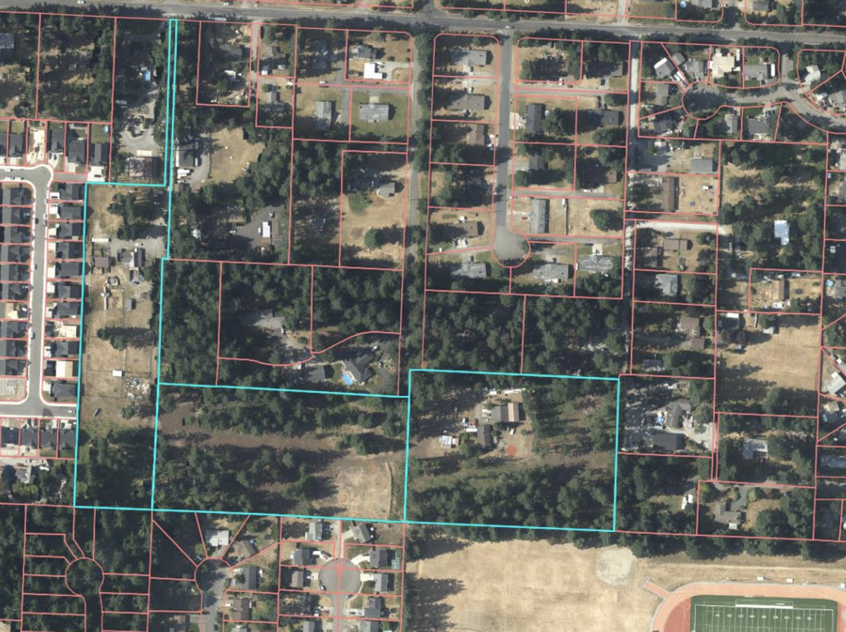 This aerial shows the teal-outlined parcels for the development. Spanaway Lake High School athletic fields are visible in the lower right corner.
