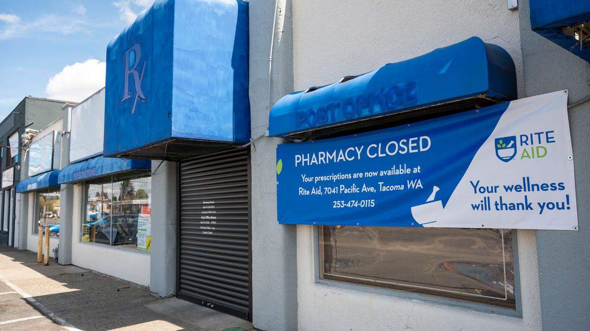 A sign informing patrons of Cost Less Prescriptions that the store and pharmacy is now closed hangs outside the building at 5431 Pacific Ave., in Tacoma on Wednesday, May 11, 2022.