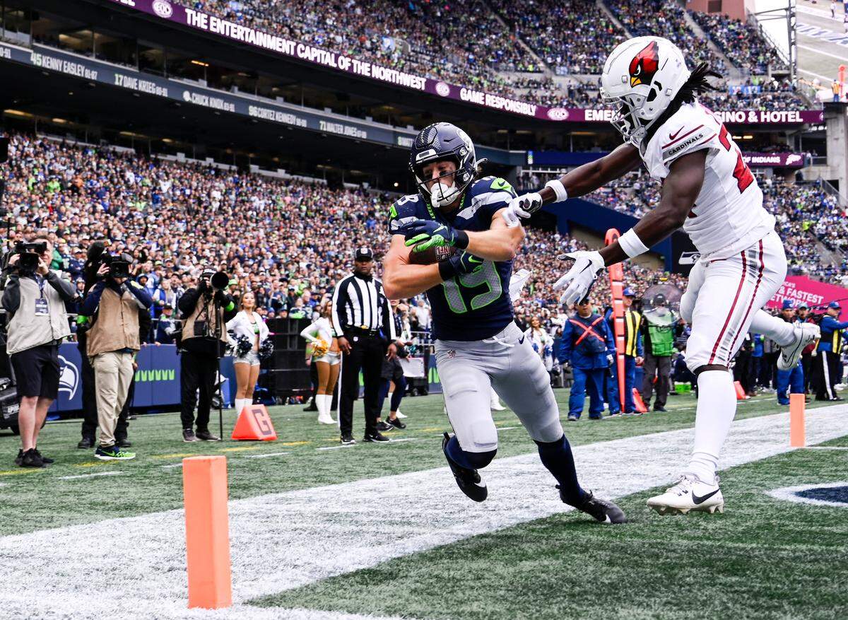 Seattle Seahawks wide receiver Jake Bobo (19) comes down with a touchdown during the second quarter of the game against the Arizona Cardinals at Lumen Field, Sunday, Oct. 22, 2023, in Seattle, Wash.