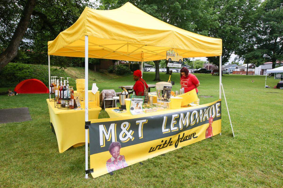 A group of community members in Puyallup celebrated Juneteenth on Saturday, June 10, 2023 at Grayland Park. Vendors sold lemonade, cakes, cookies and vegan food. Music played in the background as people danced and spoke with each other. There was a bouncy house.
