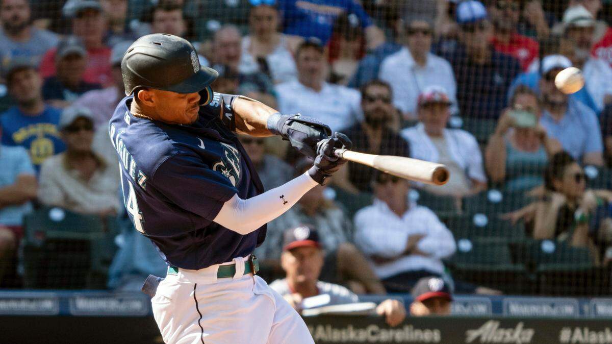 Seattle Mariners’ Julio Rodriguez hits a solo home run off Washington Nationals relief pitcher Carl Edwards Jr. during the eighth inning of a baseball game, Wednesday, Aug. 24, 2022, in Seattle. (AP Photo/Stephen Brashear)