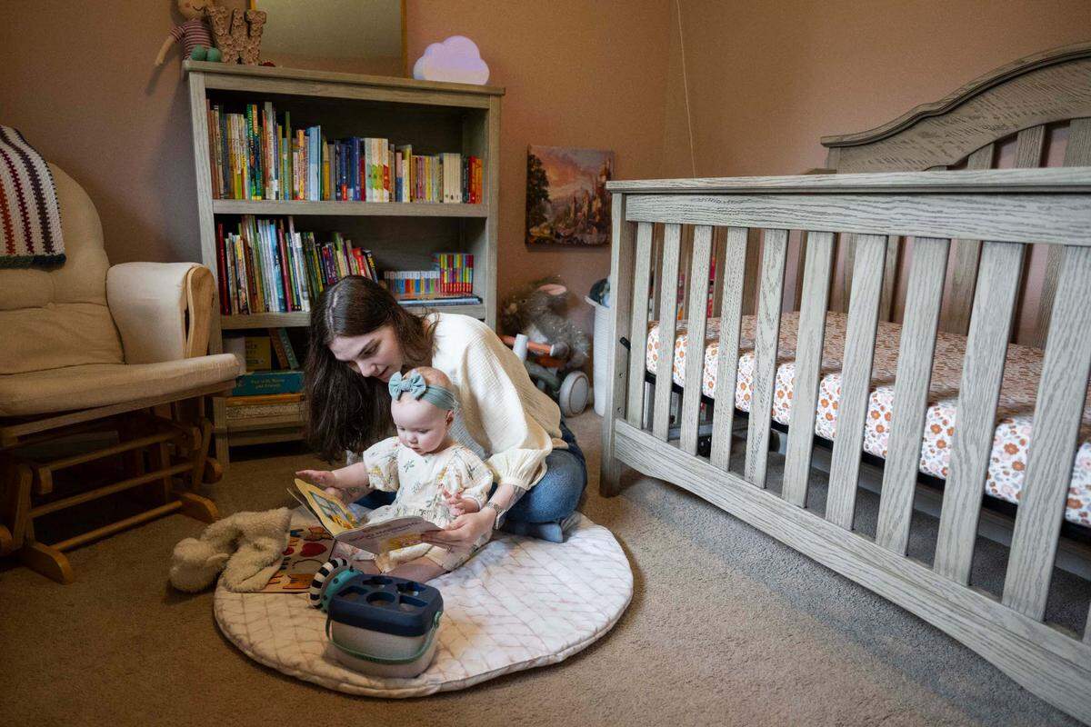 Mother and daughter Annie and Winona Thigpen, read in Winona’s nursery at home, on Wednesday, April 24, 2024, in Gig Harbor. In October 2023, parents Annie and Abraham were accused of abusing their then-5-week-old infant.