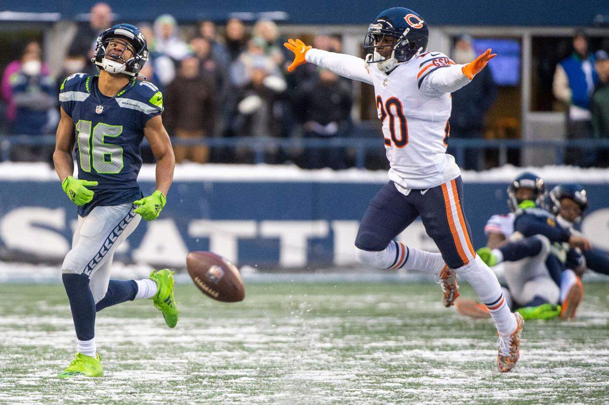 Chicago Bears cornerback Duke Shelley (center) celebrates after a pass by Seattle Seahawks quarterback Russell Wilson (right) was thrown behind wide receiver Tyler Lockett (16) on fourth down in the final minute of the fourth quarter of an NFL game on Sunday afternoon at Lumen Field in Seattle.