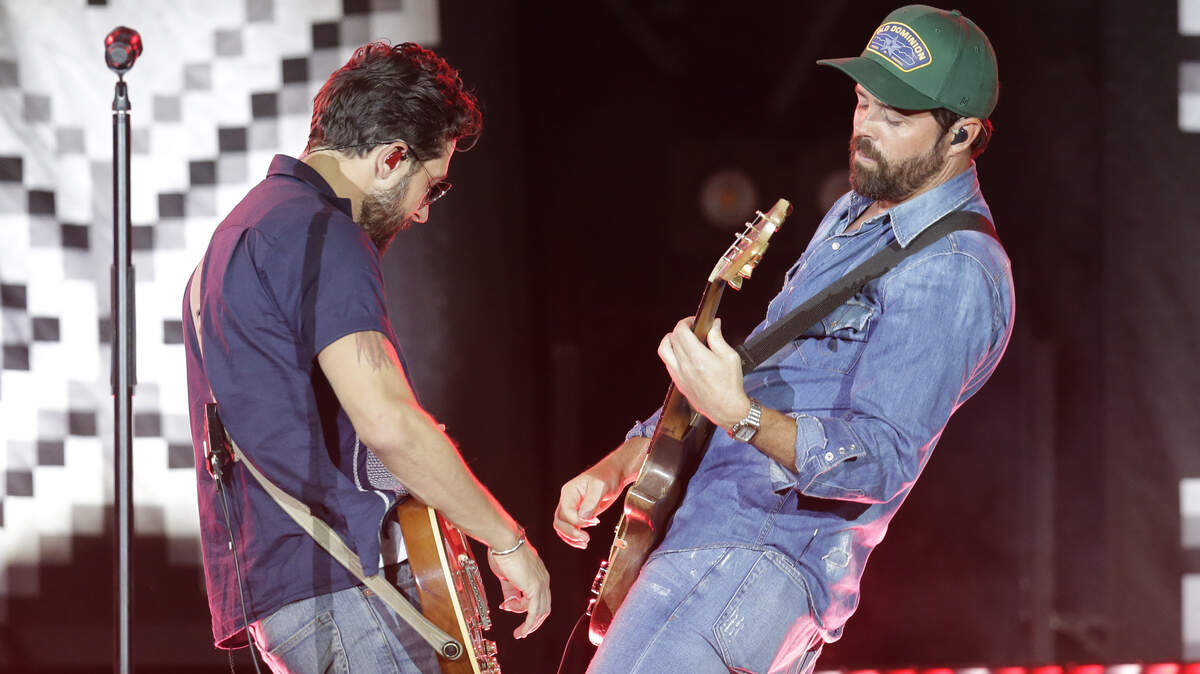 Matthew Ramsey, left, and Brad Tursi of Old Dominion perform during the “Trip Around the Sun” tour at Chase Field on Saturday, June 23, 2018, in Phoenix, Arizona.