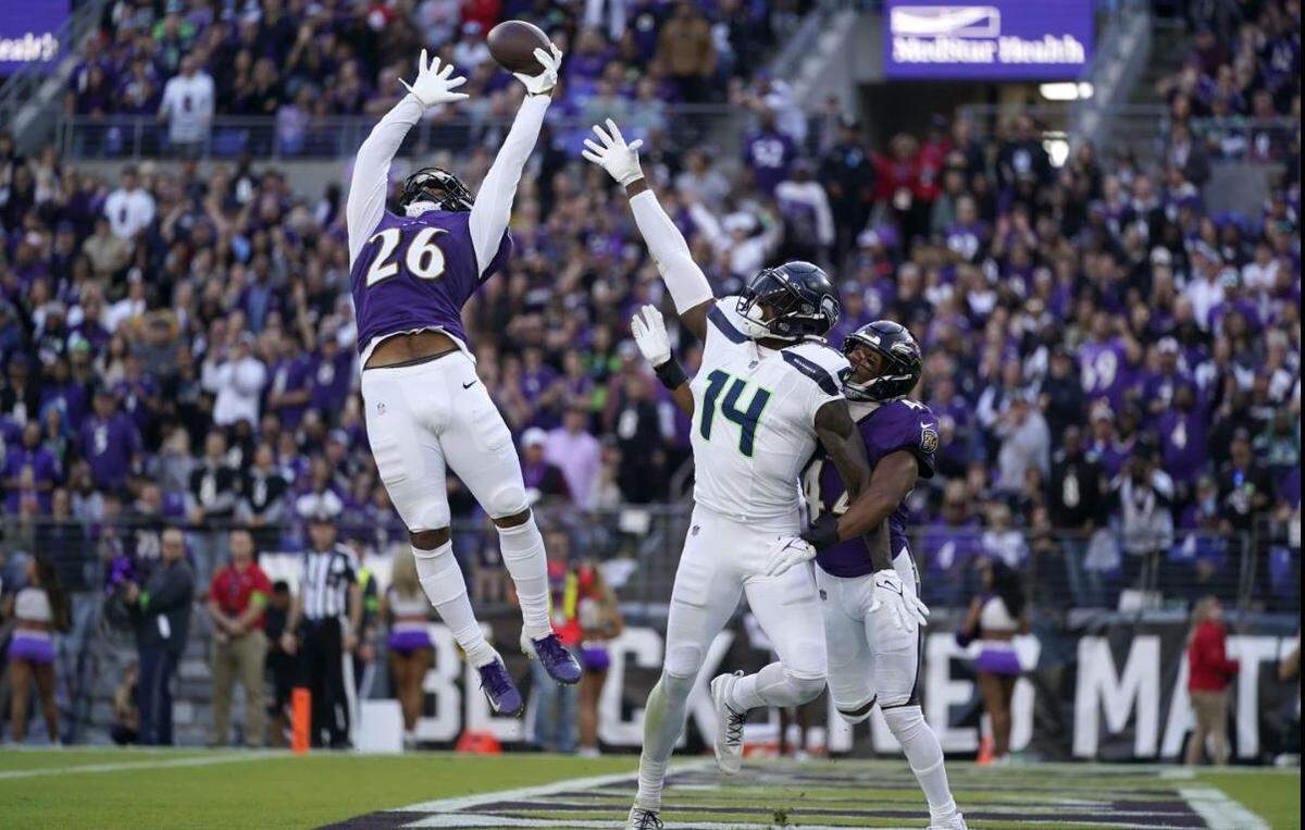 Baltimore safety Geno Stone (26) leaps in the end zone to break up Seahawks quarterback Geno Smith’s pass for receiver DK Metcalf (14) in the second half of the Ravens’ blowout win over Seattle Nov. 5, 2023, in Baltimore.