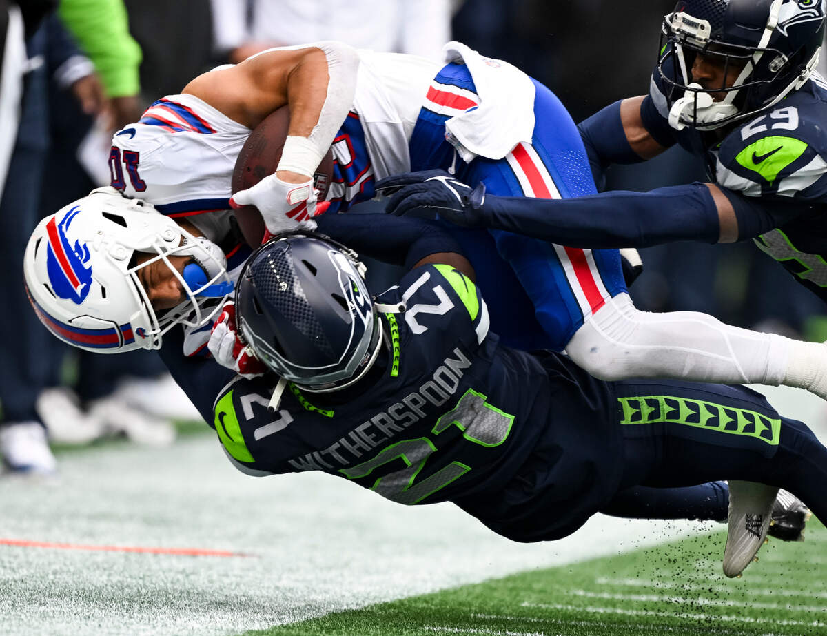 Seattle Seahawks cornerback Devon Witherspoon (21) flips Buffalo Bills wide receiver Khalil Shakir (10) out of bounds during the fourth quarter of the game at Lumen Field, on Sunday, Oct. 27, 2024 in Seattle, Wash.