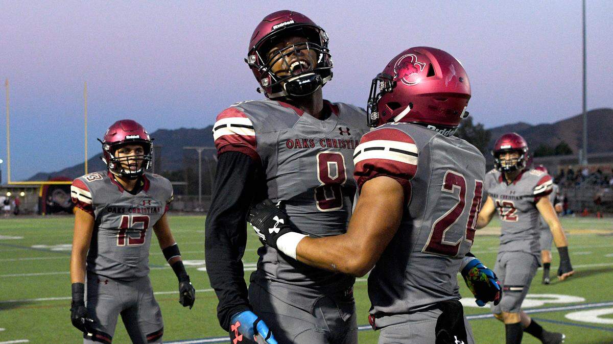 Oaks Christian’s Kayvon Thibodeaux (8) celebrates with running back Zach Charbonnet (24) after Charbonnet’s long touchdown against Alemany, Friday, Sept. 7, 2018, at Oaks Christian High School. (Photo by Michael Owen Baker, Contributing Photographer)