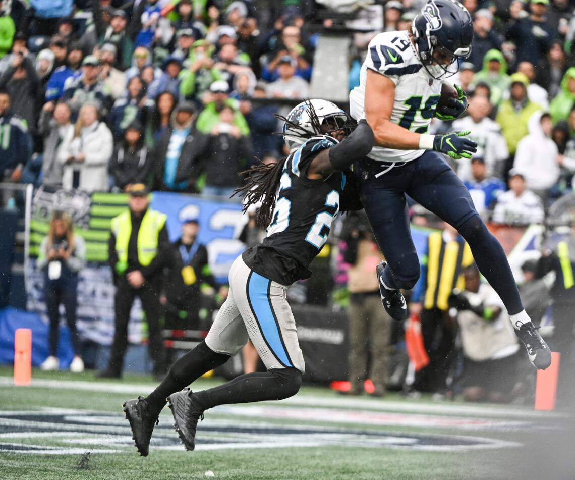 Seattle Seahawks wide receiver Jake Bobo (19) catches a touchdown in the back of the end zone abasing Carolina Panthers cornerback Donte Jackson (26) during the fourth quarter of the game at Lumen Field, Sunday, Sept. 24, 2023, Seattle, Wash.