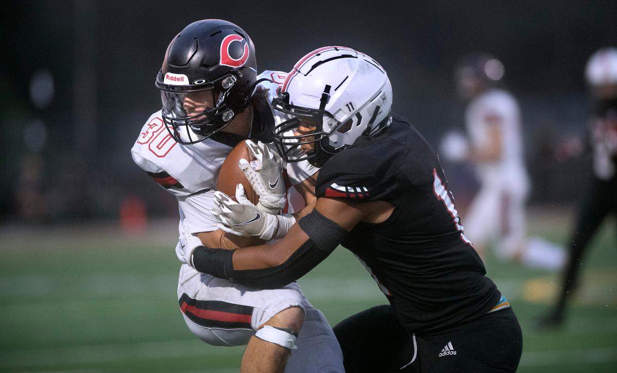 Camas running back Reid Tennant is wrapped up by Yelm linebacker Isaiah Patterson during Friday night’s season-opening football game at Yelm High School in Yelm, Washington on Friday, Sept. 2, 2022.