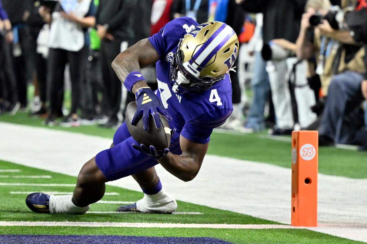 Washington wide receiver Germie Bernard (4) dives into the end zone for a touchdown against Oregon during the first half of the Pac-12 championship NCAA college football game Friday, Dec. 1, 2023, in Las Vegas. (AP Photo/David Becker)
